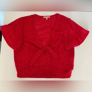 Slightly cropped red shirt